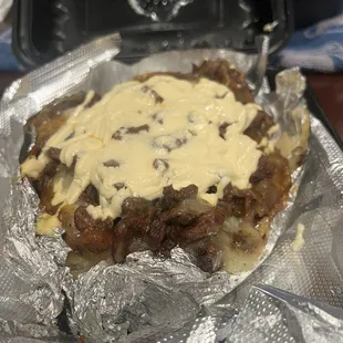 Baked potato packed with asada and cheese