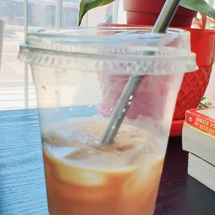 a cup of iced coffee with a straw
