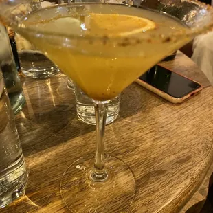 a martini with a slice of lemon on the rim