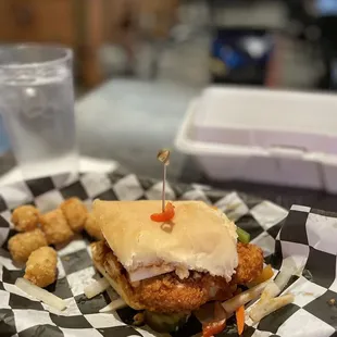 a chicken sandwich and tater tots