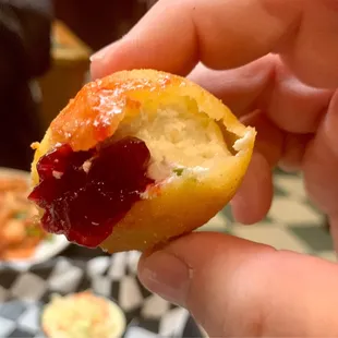 a person holding a half eaten pastry
