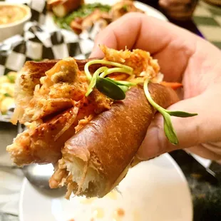 a hand holding a sandwich