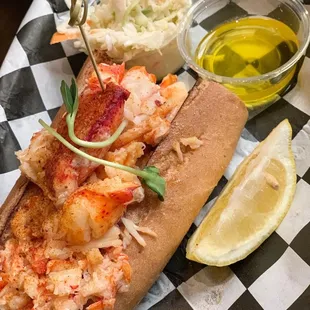 Gluten free lobster roll with drawn butter and slaw