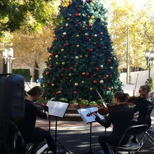 Grand opening for Walnut Creek Tesla outside in the center of the shopping at the outdoor mall on Main Street. Our Christmas Time theme