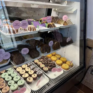 a display case filled with cupcakes