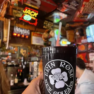 a hand holding a starbucks cup