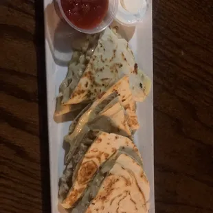 a plate of quesadillas and salsa