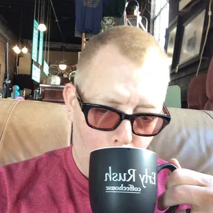 a man drinking a cup of coffee