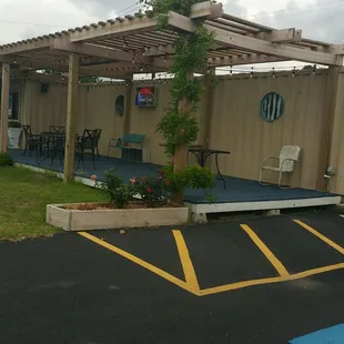 a patio with a pergolated roof