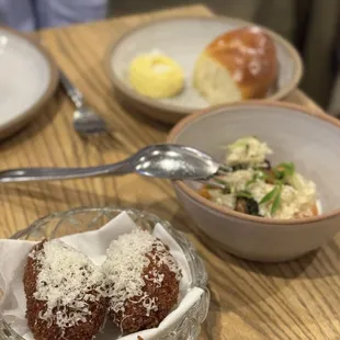 Uni carbonara supplí, California citrus salad, and Parker house rolls