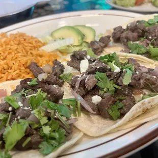 Steak tacos, with rice and beans, accoutrements