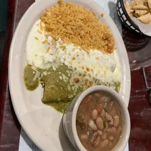 Amazing Chicken enchiladas!! - 1 with sour cream and 1 with green sauce. Rice and charra beans.