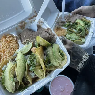 Brisket Tacos with Rice and Beans green salsa and Avocado slices along with an aguas Frescas de melon
