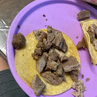 a purple plate with meat on it