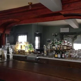 beautiful columned woodwork and mirror behind the bar.