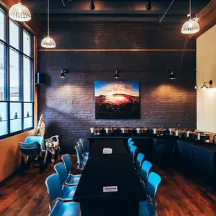 a long table with blue chairs