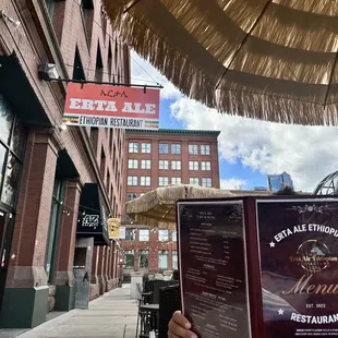 Patio seating! Straw umbrella is a fun touch.