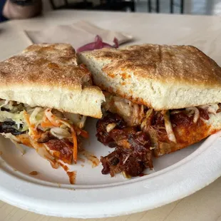 a sandwich on a paper plate