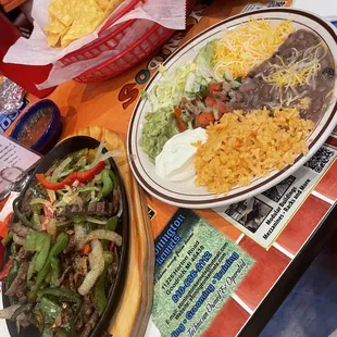 Steak fajitas,rice ,beans sour cream,lettuce, pico, and guacamole
