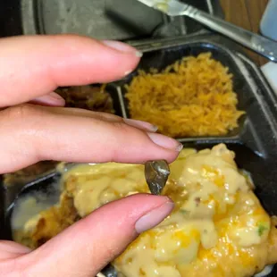 a woman's hand holding a piece of food