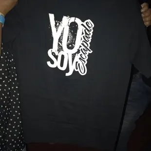 a man holding up a t - shirt with the word joy since printed on it