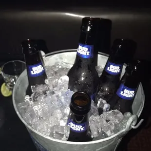 a bucket full of beer bottles