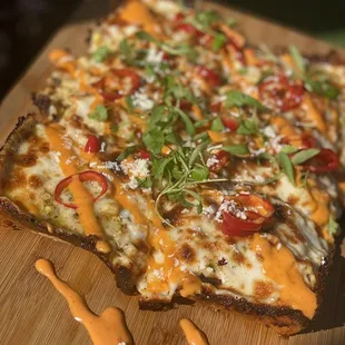 a pizza on a cutting board