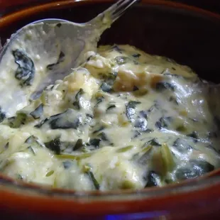 Smoked gouda spinach artichoke dip, close-up.