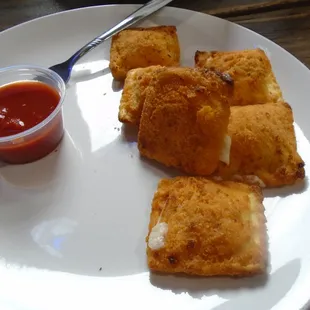 Fried ravioli with dipping sauce.