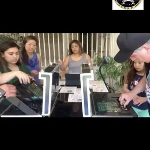 Game master monitoring  a large family playing at multiple Sabotage cases at home.