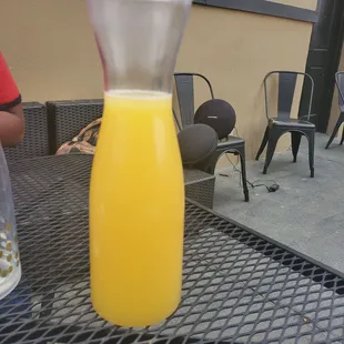 a glass of orange juice on a table