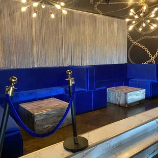 a blue booth with a rope barrier