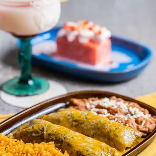 a plate of mexican food and a drink