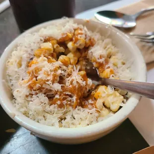 a bowl of rice and a spoon