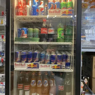 a refrigerator full of sodas and soft drinks