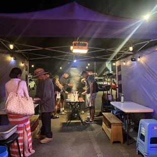 a group of people standing in a tent