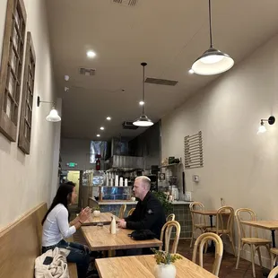 a man and a woman sitting at a table in a restaurant