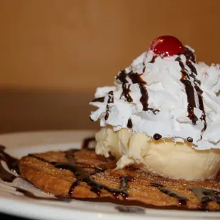 a waffle with ice cream and chocolate syrup