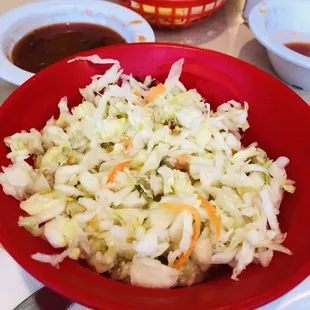 a bowl of coleslaw and tortillas