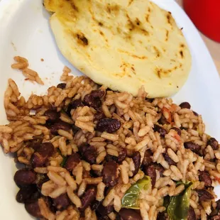 a plate of beans and rice with a pita