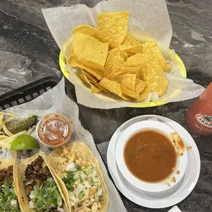 a tray of tortillas and a plate of chips