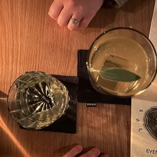 a person sitting at a table with a drink