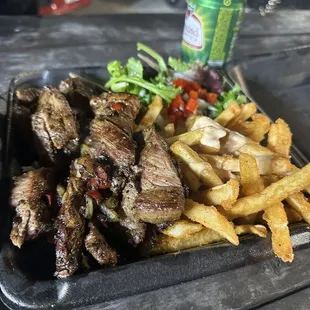 a plate of steak and french fries