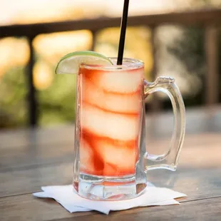 a drink with a lime wedge