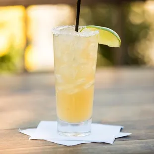 a cocktail with a lime slice