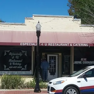 a car parked in front of a restaurant