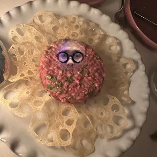 a plate with a donut decorated like a man's face