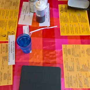 Menu under plastic on table. Easy!