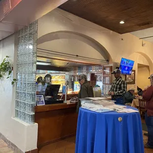Pay at the cashier. View of the bakery in the background.