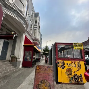 a street corner with a pizza stand